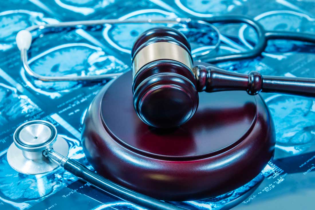 Gavel beside an X-ray of an injury from a slip and fall accident