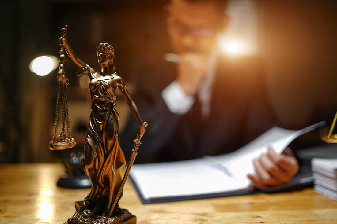 Car accident lawyer with scales of justice handling a contingency fee case