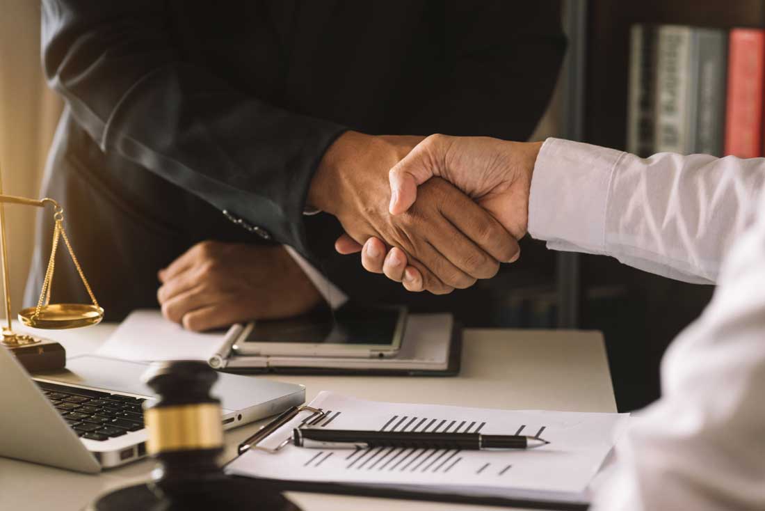 Bilingual attorney shaking hands with a client in the Rio Grande Valley